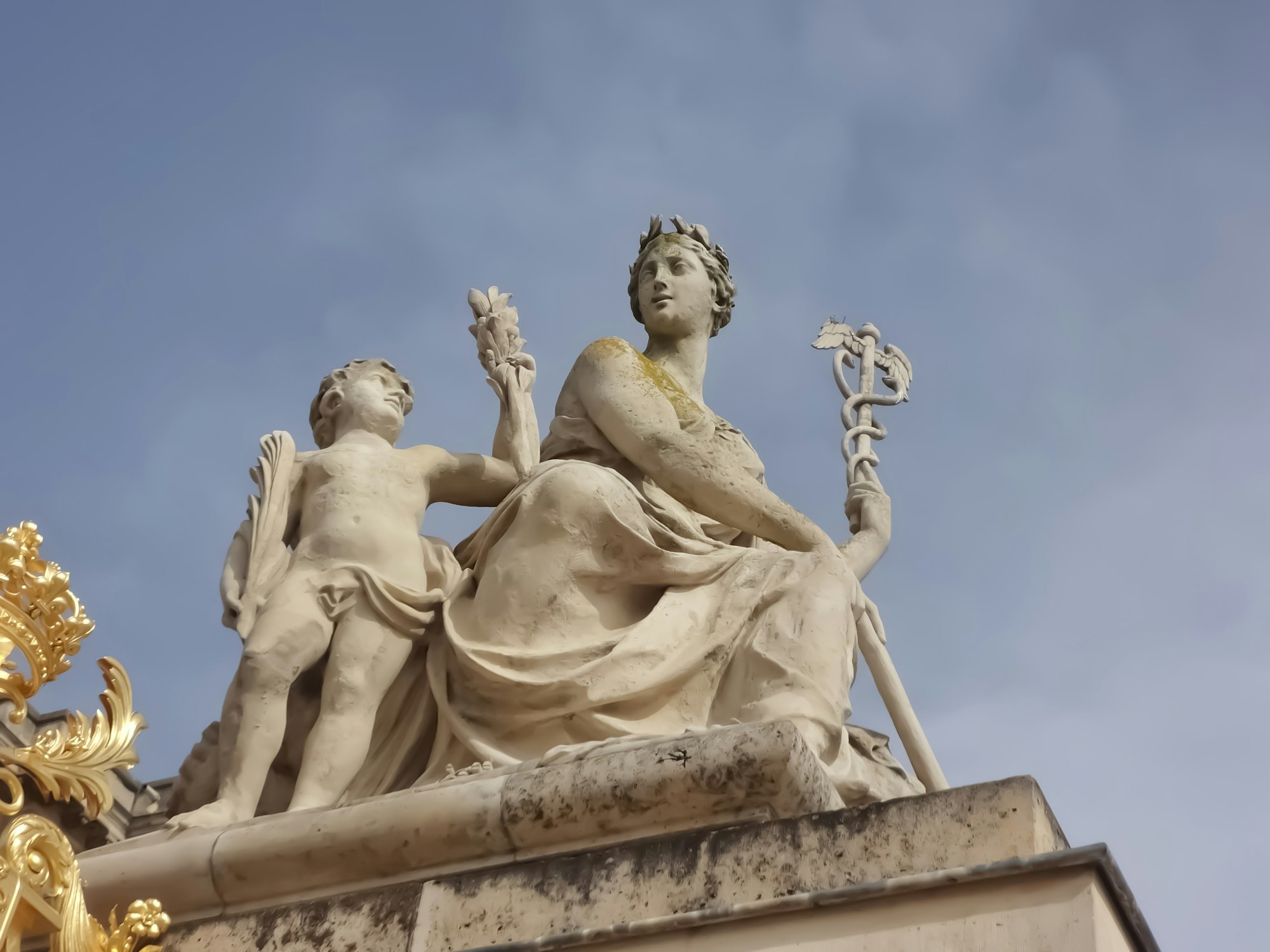 A Close up picture of a sculpture at the entrance to the Palace of Versailles